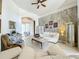 Living room features white sofas, decorative wall and a ceiling fan at 140 Rangeline Woods Cv, Longwood, FL 32750