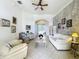 Bright living room with white sofas, tiled floors, and decorative wall art at 140 Rangeline Woods Cv, Longwood, FL 32750