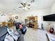 Bright living room with tiled floors, a ceiling fan, and a workspace at 140 Rangeline Woods Cv, Longwood, FL 32750