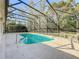 Sparkling screened pool with a view of lush green trees at 140 Rangeline Woods Cv, Longwood, FL 32750