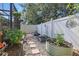 A garden area with raised garden beds and stone mulch and white fence at 1721 Lakelet Loop, Oviedo, FL 32765