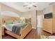 Cozy bedroom features hardwood floors, wooden dresser and closet in the ensuite bath at 1721 Lakelet Loop, Oviedo, FL 32765