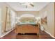 Comfortable bedroom featuring a wooden bed frame, fan, and natural light from the window at 1721 Lakelet Loop, Oviedo, FL 32765