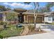 Inviting home exterior featuring vibrant landscaping, a well-maintained lawn, and an attached two-car garage at 1721 Lakelet Loop, Oviedo, FL 32765