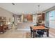 Large kitchen area featuring stainless steel appliances, breakfast bar, and a dining table at 1721 Lakelet Loop, Oviedo, FL 32765