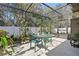 A screened patio with table and chairs, and lots of plants at 1721 Lakelet Loop, Oviedo, FL 32765