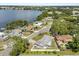 Aerial view of the property showcasing mature trees, lake views, and the surrounding community at 1792 Killarney Dr, Winter Park, FL 32789