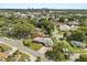 This property features a lush landscaped yard and an inviting pool surrounded by mature trees at 1792 Killarney Dr, Winter Park, FL 32789