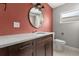 Bathroom featuring a modern vanity with a granite countertop, a round mirror, and a water closet at 1792 Killarney Dr, Winter Park, FL 32789