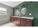 Spacious bathroom featuring double vanities, stylish mirrors, and modern lighting at 1792 Killarney Dr, Winter Park, FL 32789