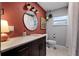 Bathroom with updated vanity and terracotta walls at 1792 Killarney Dr, Winter Park, FL 32789