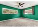 Bright bedroom with lush green walls, plush carpeting, and large windows offering a serene view at 1792 Killarney Dr, Winter Park, FL 32789