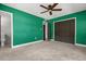 Bedroom featuring a large closet and ensuite bath, with plush carpet and a ceiling fan at 1792 Killarney Dr, Winter Park, FL 32789