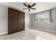 A well-lit bedroom featuring a convenient murphy bed and ceiling fan for added comfort at 1792 Killarney Dr, Winter Park, FL 32789