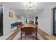 Mid-century modern dining room with wood table and statement light fixture at 1792 Killarney Dr, Winter Park, FL 32789