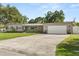 View of a one-story home with an attached garage, gray brick, and a concrete driveway at 1792 Killarney Dr, Winter Park, FL 32789