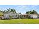 Charming single-story home boasts lush landscaping, a brick facade and a detached two-car garage at 1792 Killarney Dr, Winter Park, FL 32789