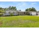 Charming one-story home with gray brick, brown trim, a spacious lawn, and mature trees at 1792 Killarney Dr, Winter Park, FL 32789