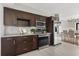 Open kitchen features stainless steel appliances, wood cabinetry, and neutral backsplash at 1792 Killarney Dr, Winter Park, FL 32789