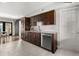 Well-lit kitchen features dark wood cabinets, stainless appliances, and white countertops at 1792 Killarney Dr, Winter Park, FL 32789