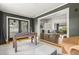 Open-concept living space with a foosball table and fireplace, creating a welcoming and entertaining atmosphere at 1792 Killarney Dr, Winter Park, FL 32789