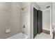 Modern walk-in shower with gray tiles, a built-in seat, and a shower door for a sleek and functional design at 1792 Killarney Dr, Winter Park, FL 32789
