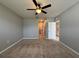 Large bedroom with ceiling fan and hallway access at 193 Grove Branch Rd, Winter Haven, FL 33880