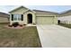 House exterior featuring a two-car garage and well-manicured lawn at 193 Grove Branch Rd, Winter Haven, FL 33880