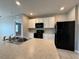 Kitchen island with double sink and granite countertop at 193 Grove Branch Rd, Winter Haven, FL 33880