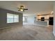 Open living room with neutral carpeting and kitchen view at 193 Grove Branch Rd, Winter Haven, FL 33880