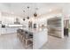 Modern kitchen featuring white cabinets, stainless steel appliances, and a large island at 193 Hampton Loop, Davenport, FL 33837