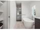 Modern bathroom with soaking tub, glass shower, and light wood floors at 1975 Biscayne Dr, Winter Park, FL 32789