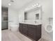 Modern bathroom with double vanity, urinal, and shower at 1975 Biscayne Dr, Winter Park, FL 32789