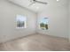 Bright bedroom with light wood floors and two windows at 1975 Biscayne Dr, Winter Park, FL 32789