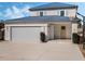 Two-story house with a blue metal roof, attached garage, and basketball hoop at 1975 Biscayne Dr, Winter Park, FL 32789