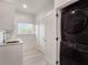 Bright laundry room with stacked washer and dryer at 1975 Biscayne Dr, Winter Park, FL 32789