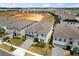 Aerial view of a modern home with lush landscaping, surrounded by neighboring houses at 1986 Summer Dr, Davenport, FL 33897