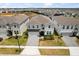 Aerial shot of a two-story home showcasing its well-manicured front yard and driveway at 1986 Summer Dr, Davenport, FL 33897