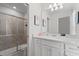 Bright bathroom featuring a white vanity, shower with glass door, and neutral tile at 1986 Summer Dr, Davenport, FL 33897