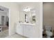 Bathroom with a double sink vanity, ample cabinet space, and neutral tile at 1986 Summer Dr, Davenport, FL 33897
