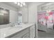 Bright bathroom features a double sink vanity, modern fixtures, and a view into the bedroom at 1986 Summer Dr, Davenport, FL 33897