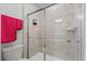 Clean and modern bathroom with a glass-enclosed shower and convenient towel rack at 1986 Summer Dr, Davenport, FL 33897