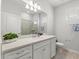 Well-lit bathroom features a large mirror, white vanity, and a separate shower stall at 1986 Summer Dr, Davenport, FL 33897