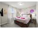 Charming bedroom with a bed and storage, window with natural light, a TV, and whimsical decor at 1986 Summer Dr, Davenport, FL 33897