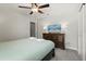 Cozy bedroom features a TV, dresser, ceiling fan, and a calming color palette at 1986 Summer Dr, Davenport, FL 33897