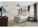 Well-lit bedroom with a king bed, stylish decor, and a ceiling fan at 1986 Summer Dr, Davenport, FL 33897