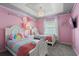 Lovely bedroom with pink walls, charming decor, and two twin beds for a whimsical touch at 1986 Summer Dr, Davenport, FL 33897