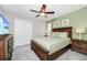 Bedroom with a king-size bed, TV, and green accent wall at 1986 Summer Dr, Davenport, FL 33897