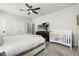 Bedroom featuring a queen bed, dark dresser, and a crib, ideal for families at 1986 Summer Dr, Davenport, FL 33897