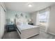 Comfortable bedroom features a bed with nautical theme, blue end tables and a window with sheer curtains at 1986 Summer Dr, Davenport, FL 33897